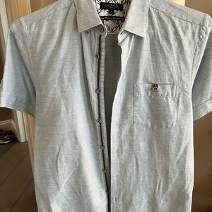 Ted Baker size 3 which is equivalent to a medium short sleeve light blue cotton.